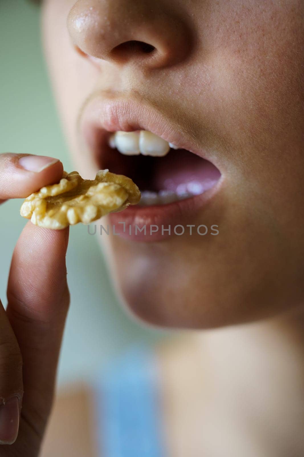 Crop anonymous teenage girl about to eat delicious walnut by javiindy