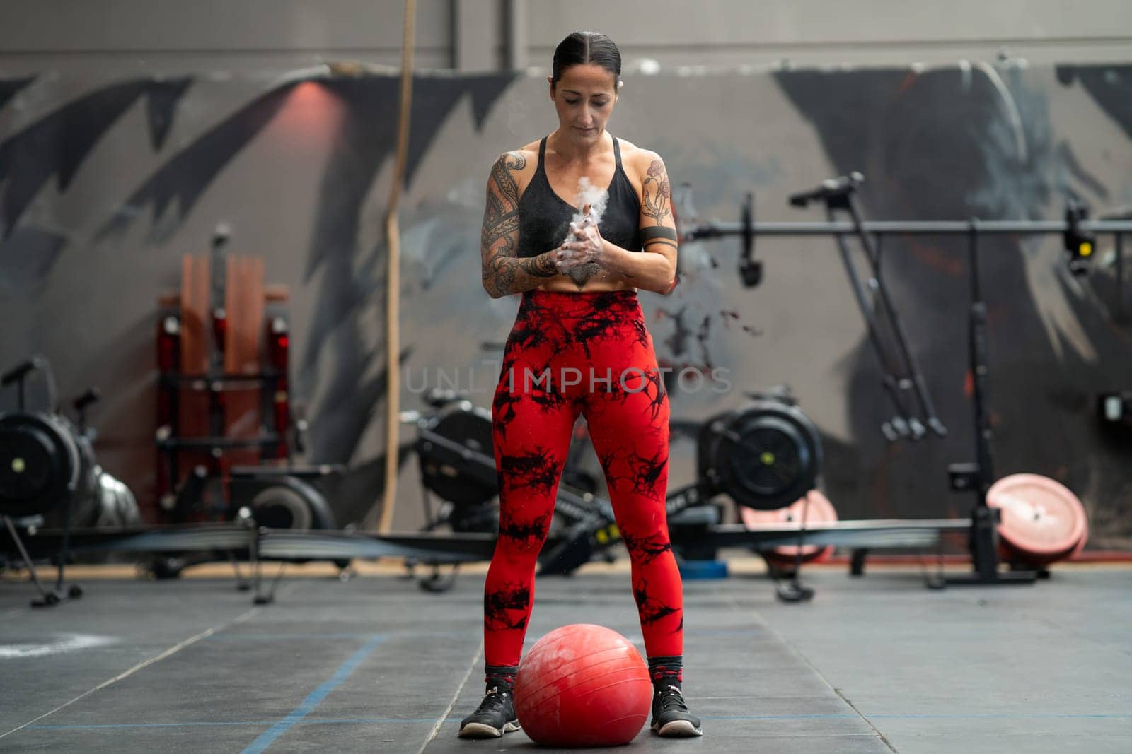 Woman ready to use a medicinal ball in a gym by javiindy