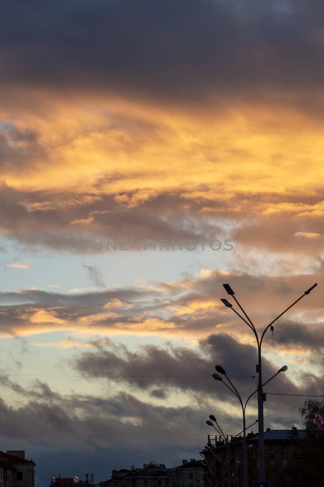 Bright yellow clouds at sunset in sky close up