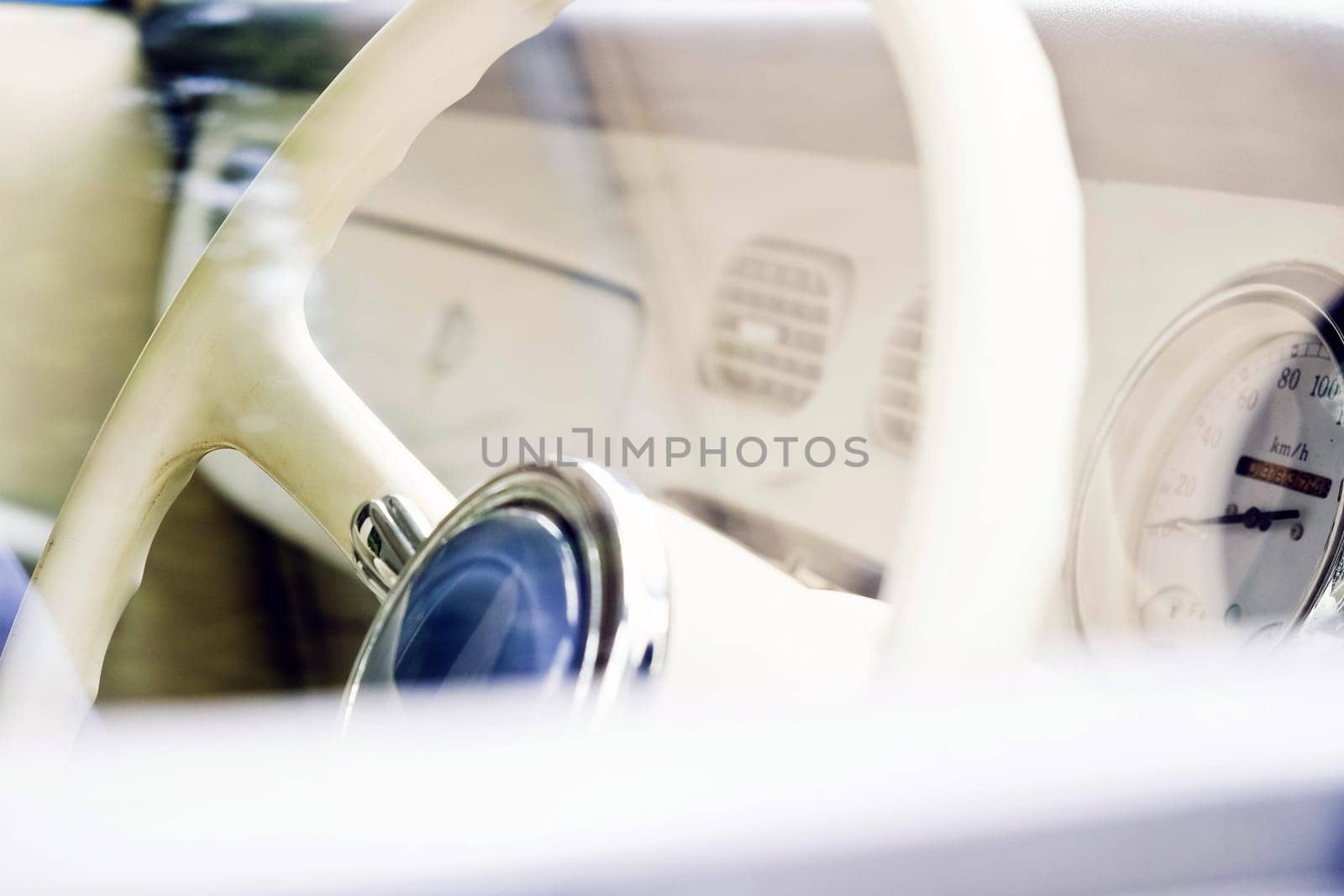 Steering wheel and dashboard of a classic car. Vintage style.