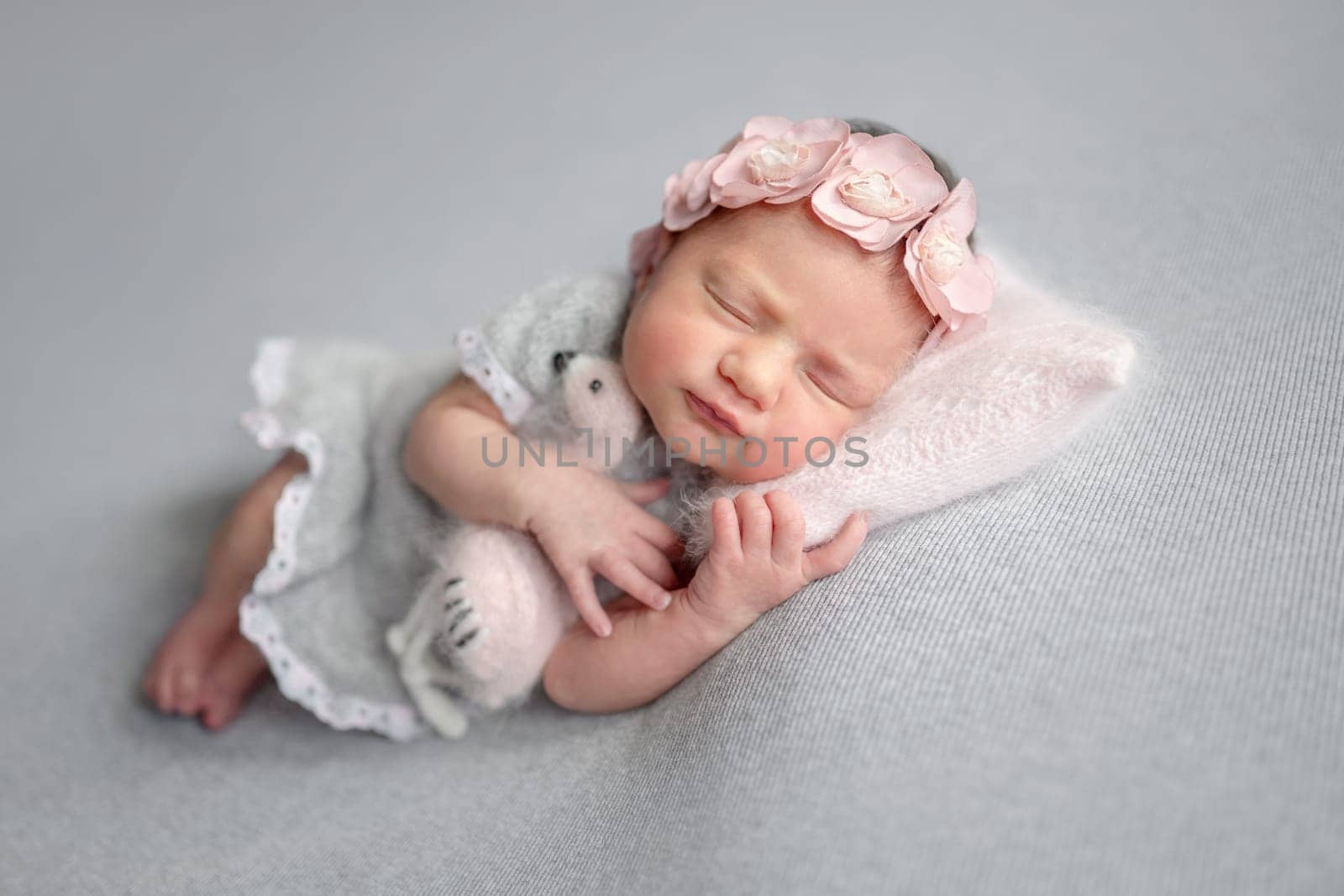 Newborn Girl Sleeps In Gray Dress With Flamingo Toy by tan4ikk1