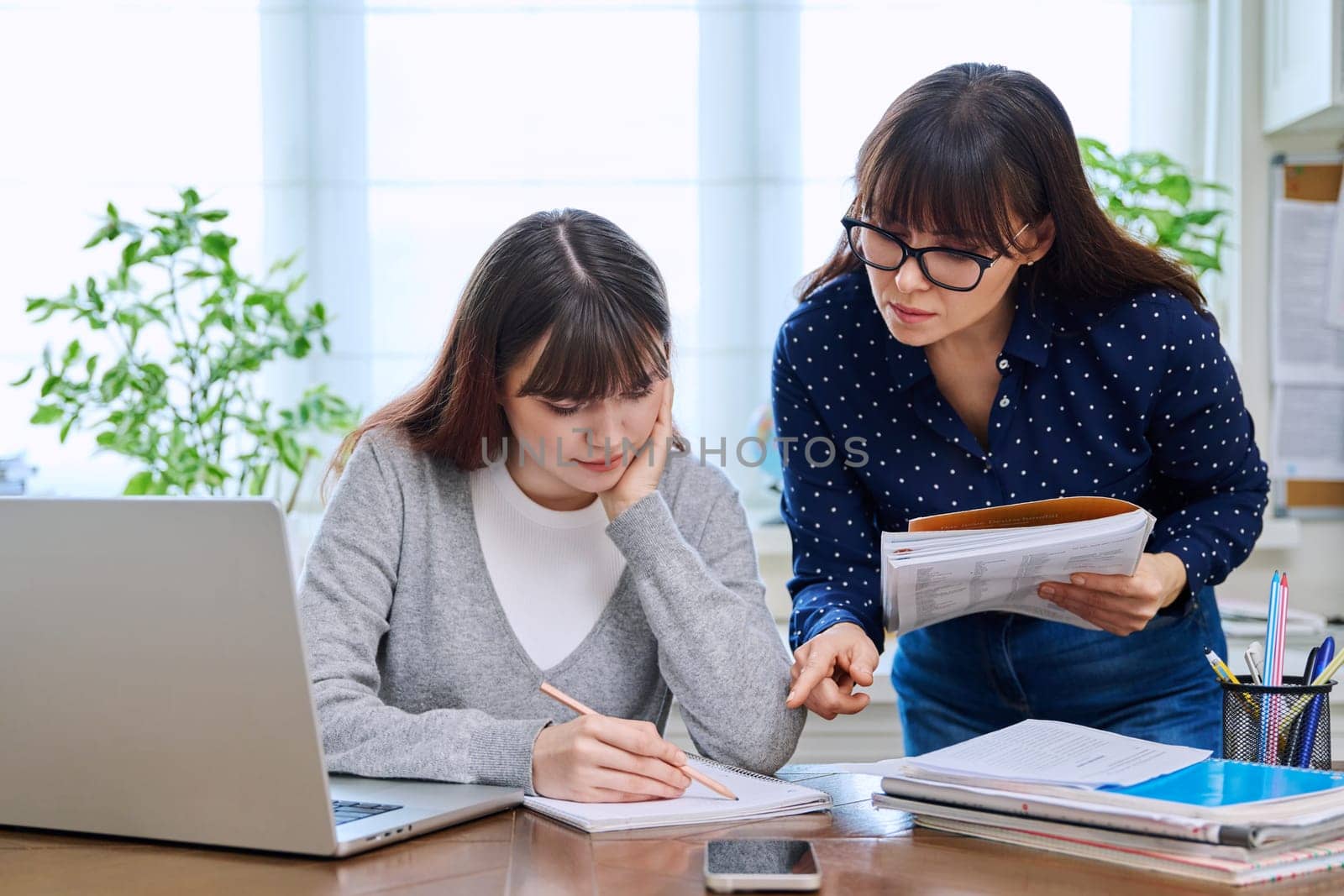 Teenage student studying at desk with computer, trainer mentor helping teaching by VH-studio