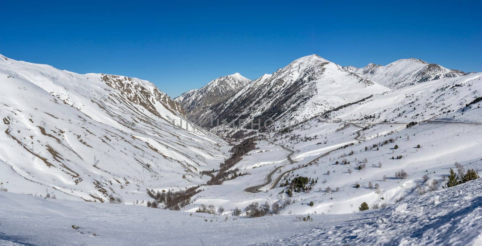 Winding Through Winter: Snowy Mountain Pass by Juanjo39