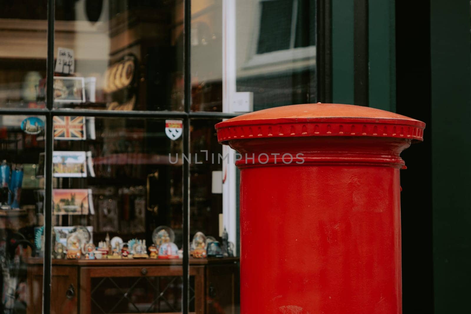 Red pillar mail box on a busy street in Canterbury by Suteren
