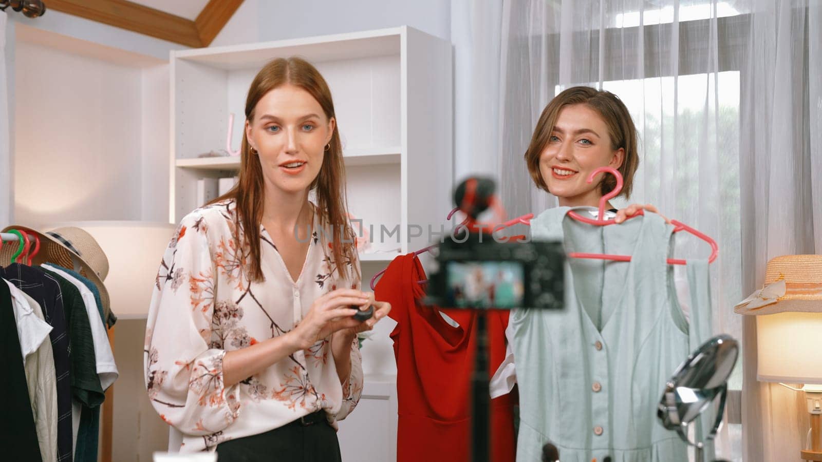Two women influencer shoot live streaming review clothes prim social media by biancoblue