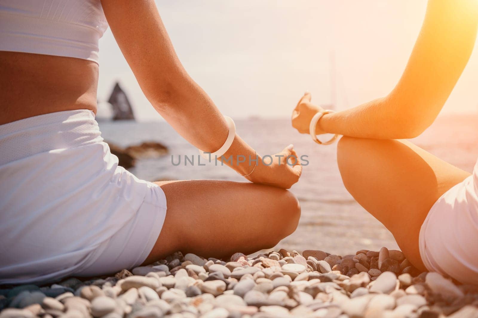 Woman sea yoga. Back view of free calm happy satisfied woman with long hair standing on top rock with yoga position against of sky by the sea. Healthy lifestyle outdoors in nature, fitness concept.