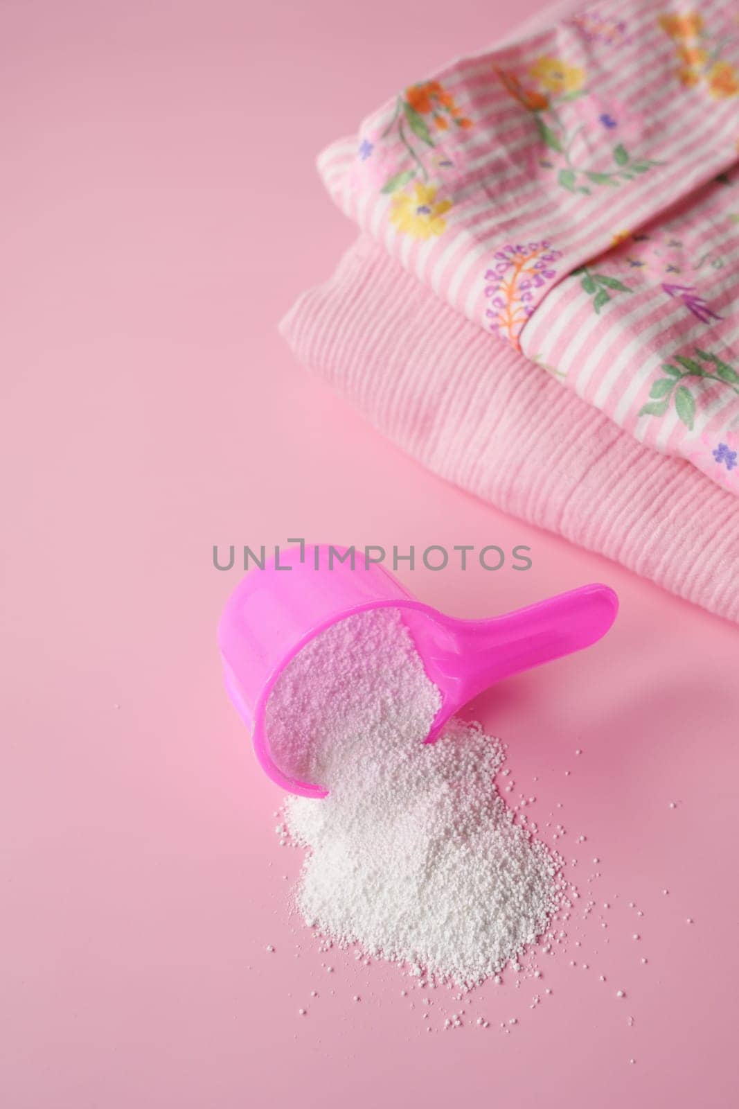 Washing powder in plastic spoon on blue background by towfiq007