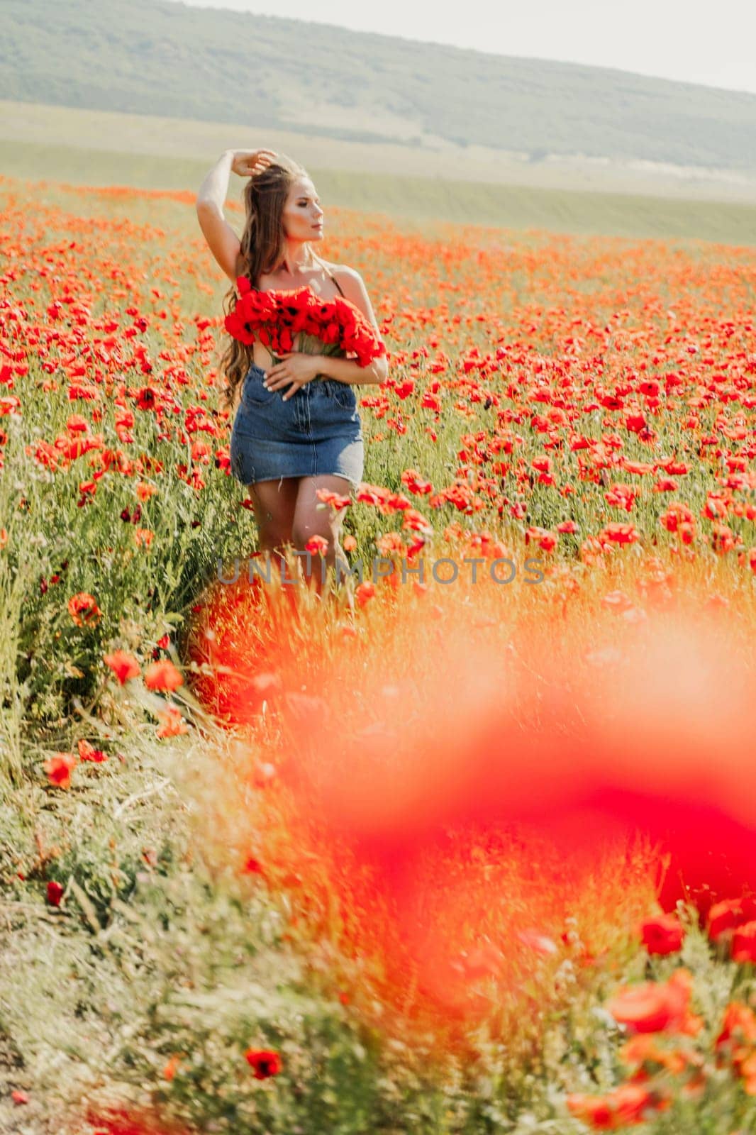 Woman poppies field. portrait happy woman with long hair in a poppy field and enjoying the beauty of nature in a warm summer day. by Matiunina