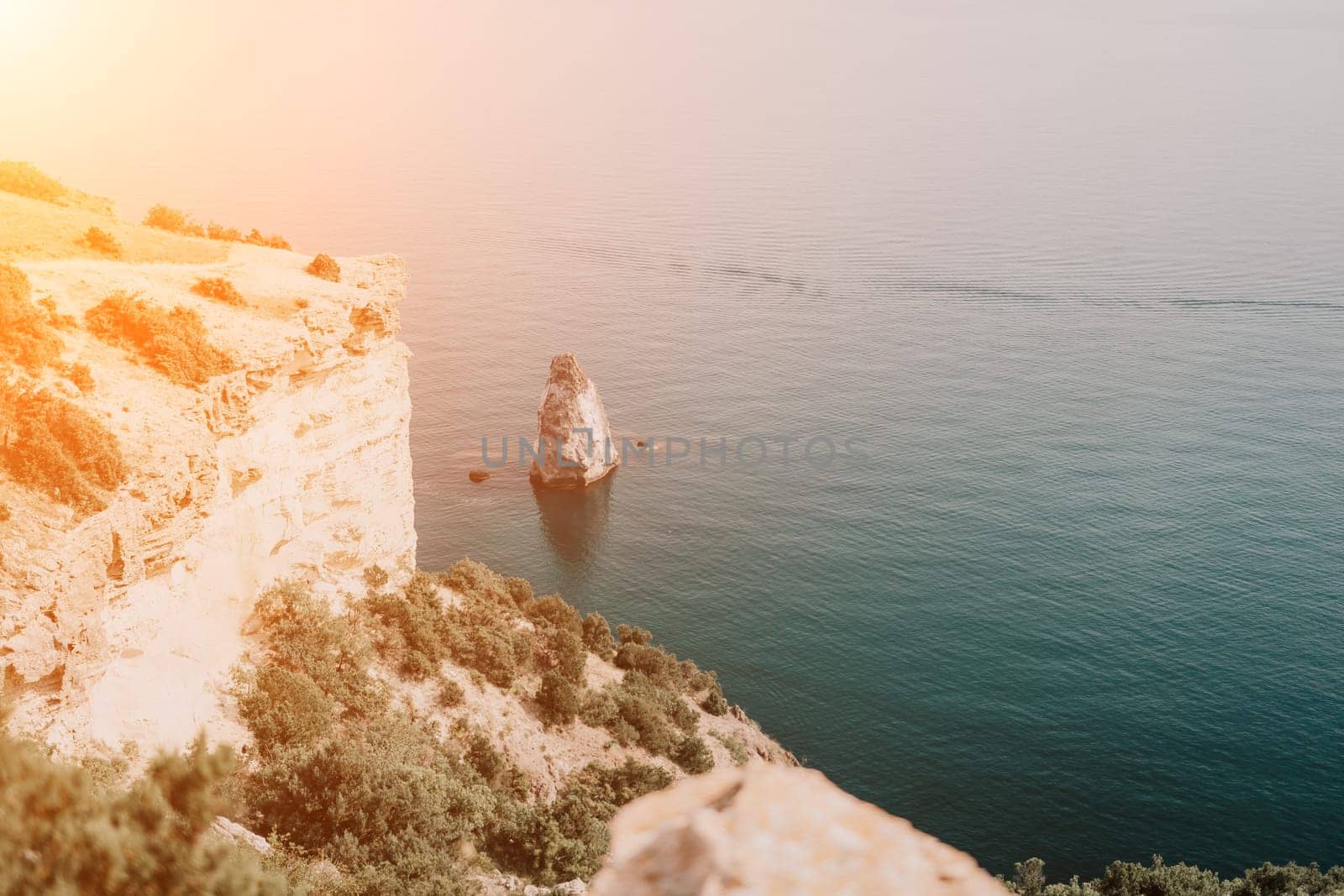 Woman travel sea. Happy tourist enjoy taking picture outdoors for memories. Woman traveler looks at the edge of the cliff on the sea bay of mountains, sharing travel adventure journey by panophotograph