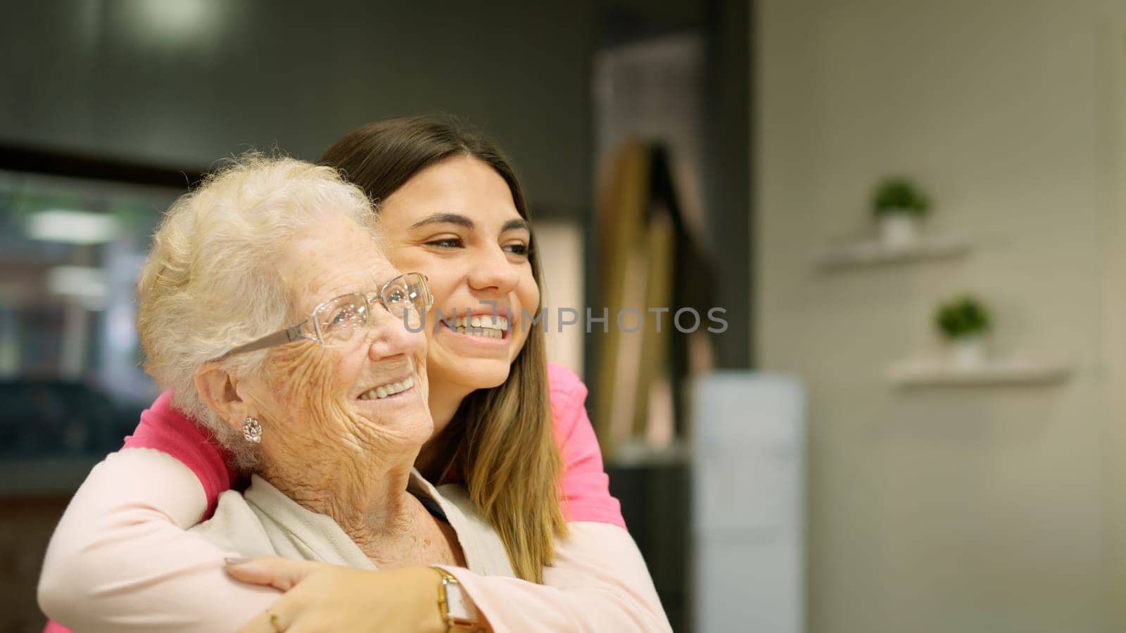 Smiling grandmother and granddaughter looking at copy space by ivanmoreno