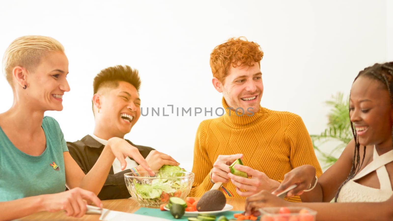 Group of multiethnic friends preparing a salad at home