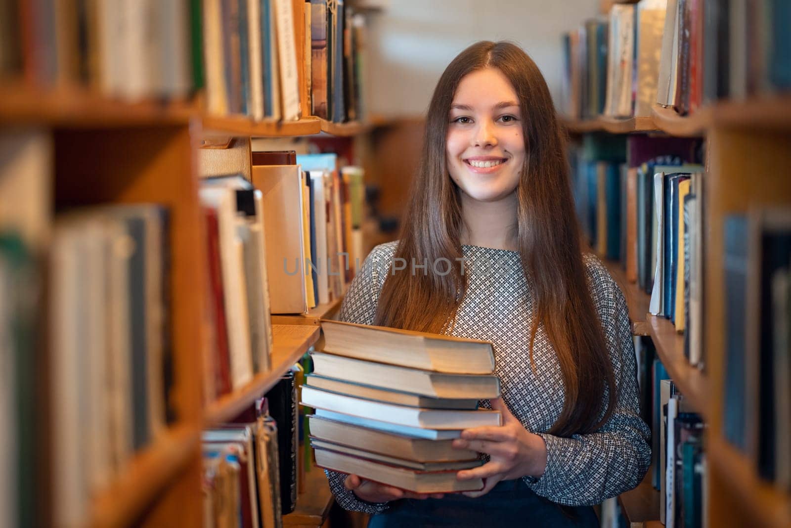 Happy girl getting ready for university assignments, looking through literature
