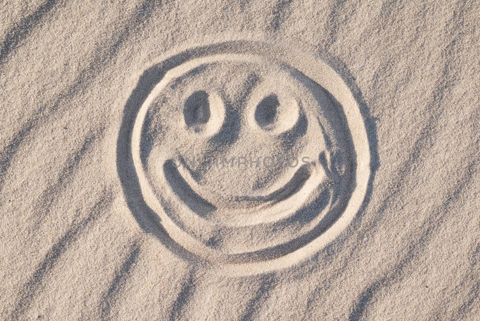 Happy smile symbol on beach sand by VitaliiPetrushenko