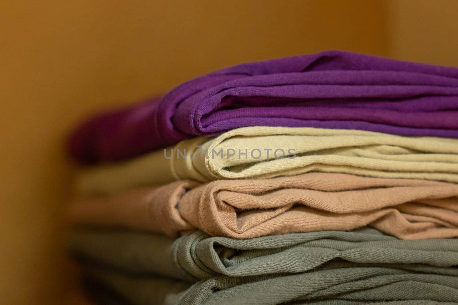 Clean folded t shirts in wardrobe by VitaliiPetrushenko