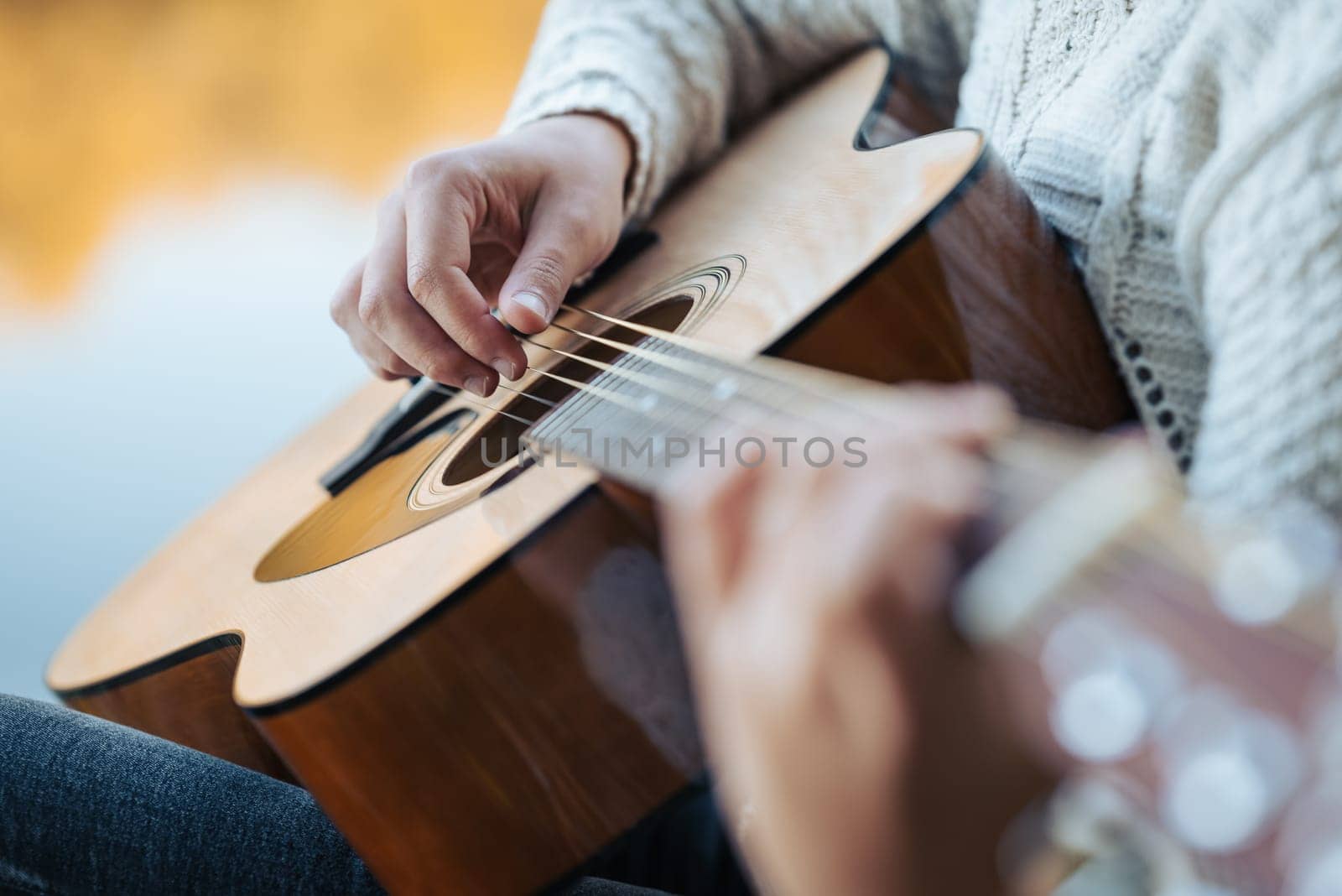 Close up of a young girl playing the guitar by VitaliiPetrushenko
