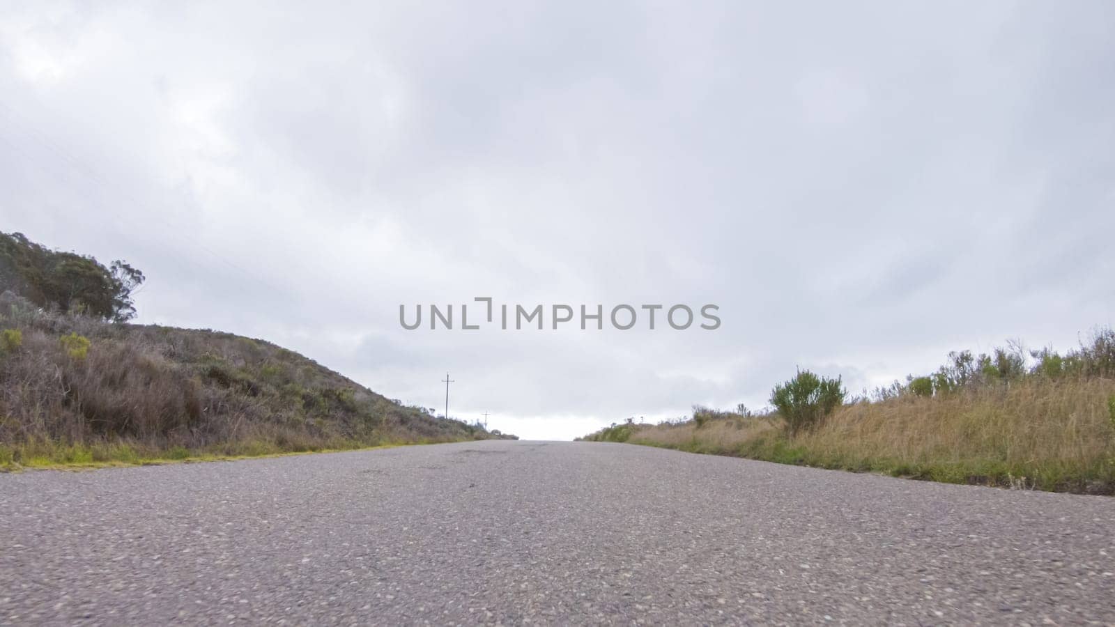 In this serene winter scene, a vehicle carefully makes its way along Los Osos Valley Road and Pecho Valley Road within Montana de Oro State Park.