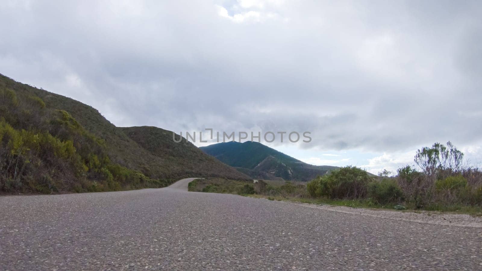 In this serene winter scene, a vehicle carefully makes its way along Los Osos Valley Road and Pecho Valley Road within Montana de Oro State Park.