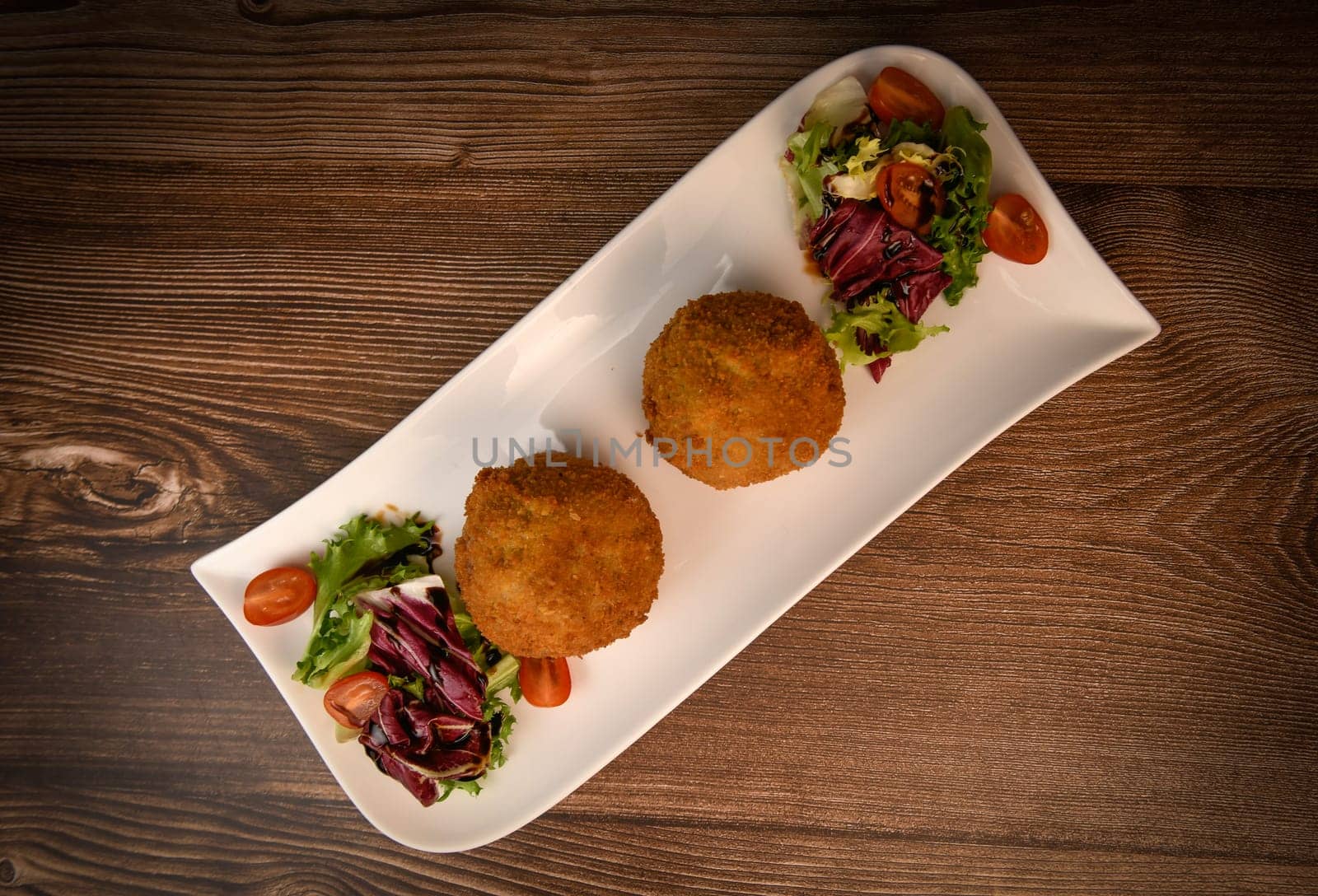 RECIPE FOR BREADED BEEF MEATBALLS STUFFED WITH A SOFT BOILED EGG. High quality photo