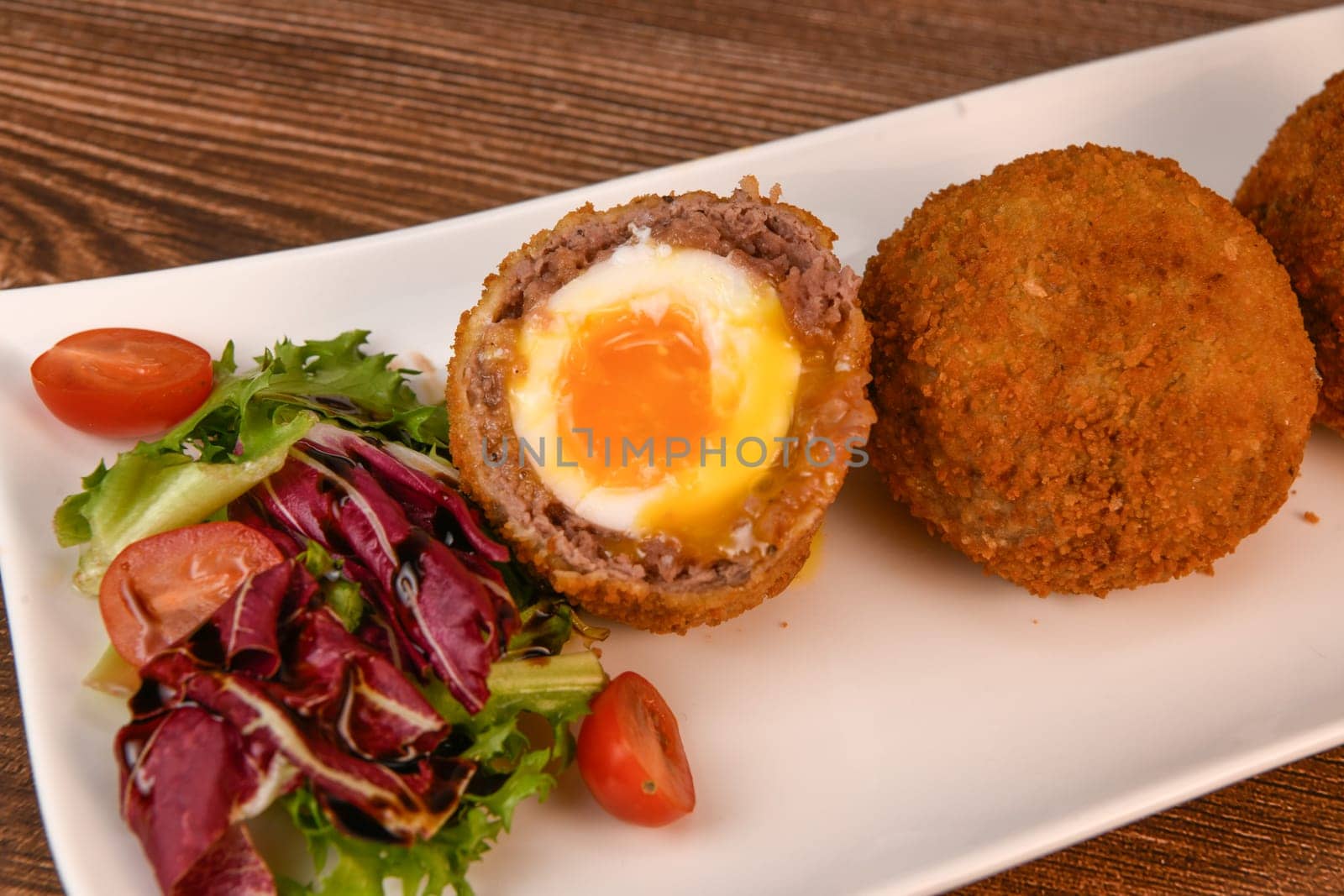 RECIPE FOR BREADED BEEF MEATBALLS STUFFED WITH A SOFT BOILED EGG by FreeProd