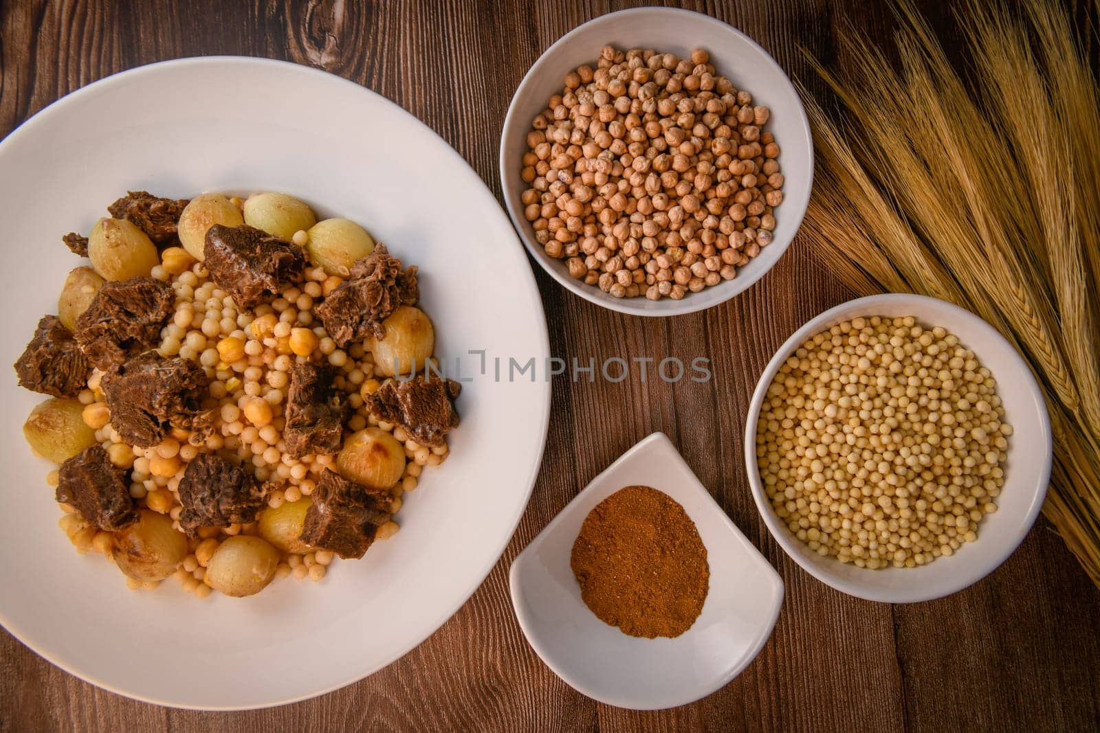 Moughrabieh is a popular dish in the Lebanese cuisine, LEBANESE RECIPE FOR MOUGHRABIEH WITH BEEF AND SMALL ONIONS, SEMOLINA PEARLS AND CHICKPEAS. High quality photo