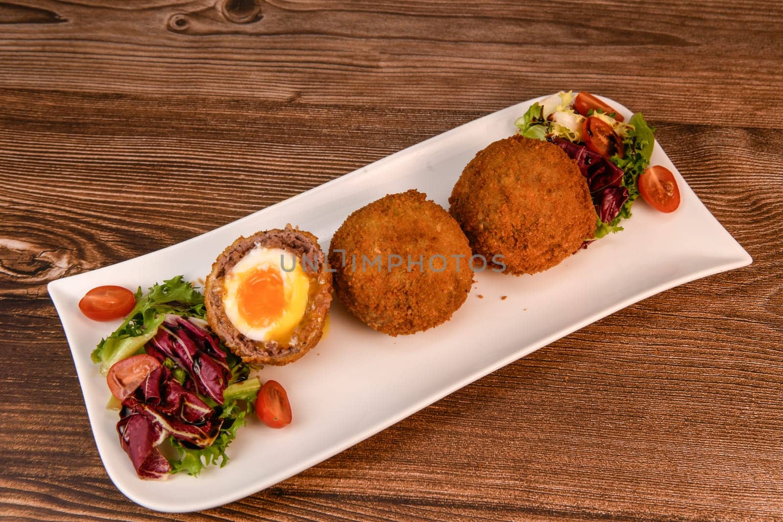 RECIPE FOR BREADED BEEF MEATBALLS STUFFED WITH A SOFT BOILED EGG by FreeProd