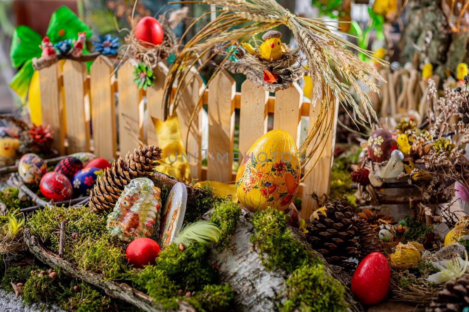In this captivating Easter scene, a bed of moss adorned with birch bark, twigs, and vibrant Easter eggs creates a wonderland.