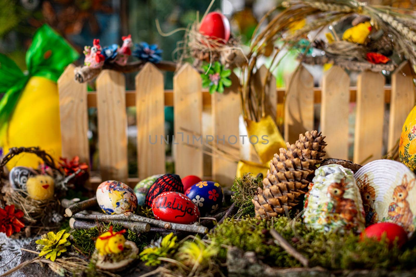 In this captivating Easter scene, a bed of moss adorned with birch bark, twigs, and vibrant Easter eggs creates a wonderland.