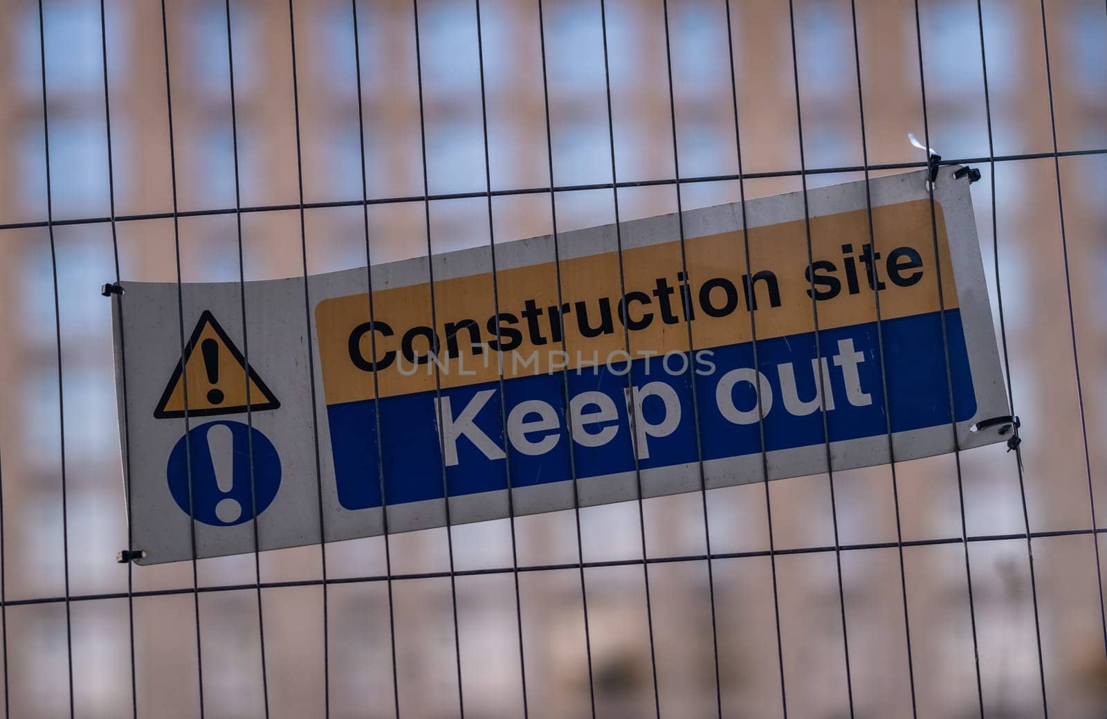A Keep Out Sign On A Fence At A Construction Site