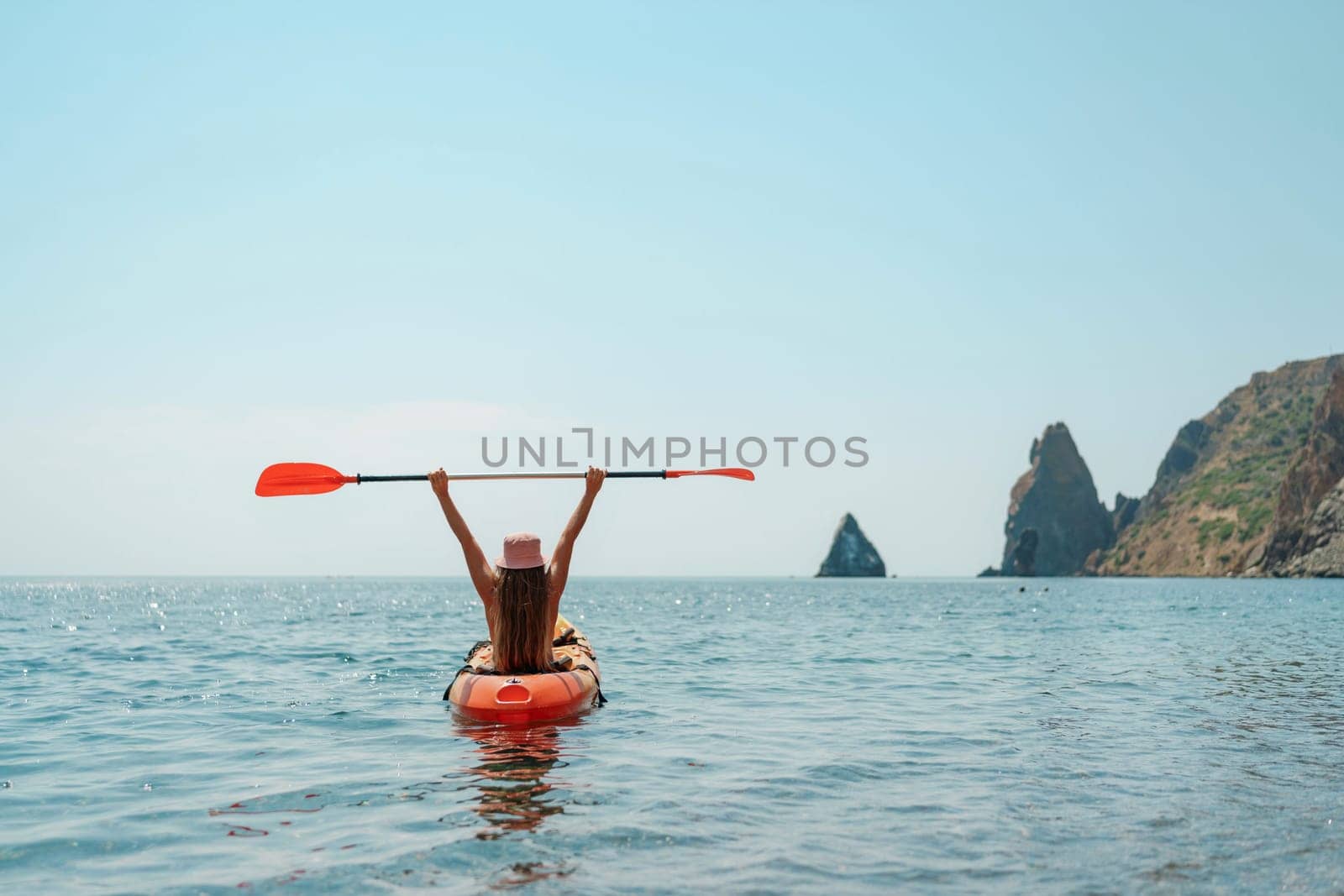 Kayak sea woman. Happy attractive woman with long hair in red swimsuit, swimming on kayak. Summer holiday vacation and travel concept