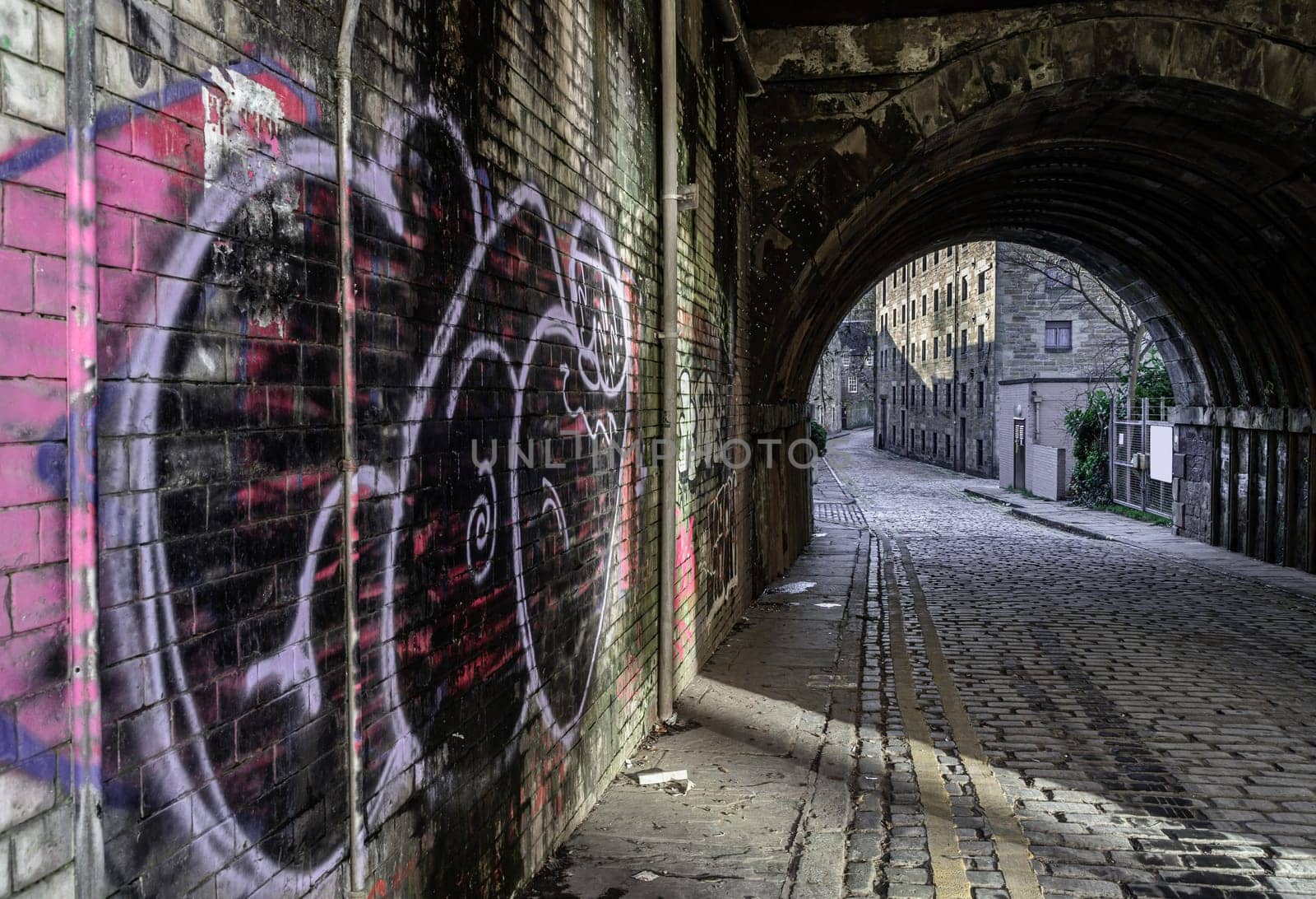 Edinburgh, Scotland-Jan 17, 2024 - View of tunnel under South Bridge on Cowgate street in Edinburgh, The capital of Scotland. Space for text, Selective focus.