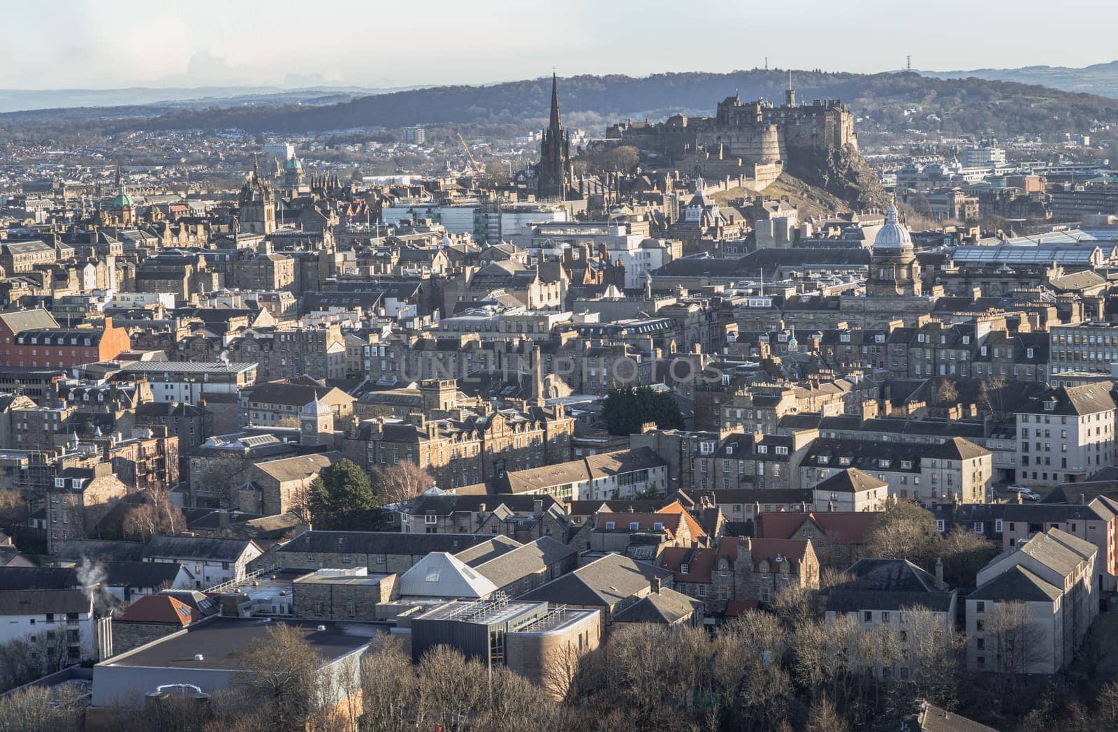 Edinburgh, Scotland - Jan 17, 2024 - Amazing Edinburgh Cityscape and Edinburgh Castle seen from the top of Salisbury Crags. Destinations in Europe, Copy space, Selective focus.