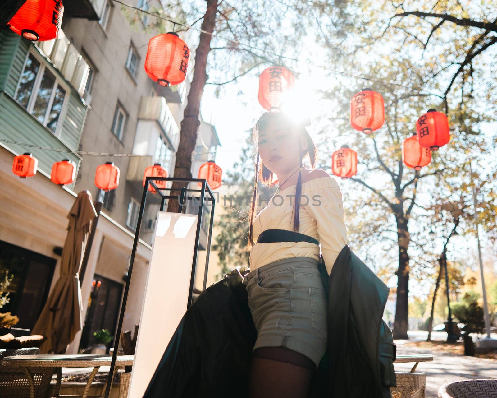 Portrait of an Asian woman against the background of Chinese lanterns outdoors