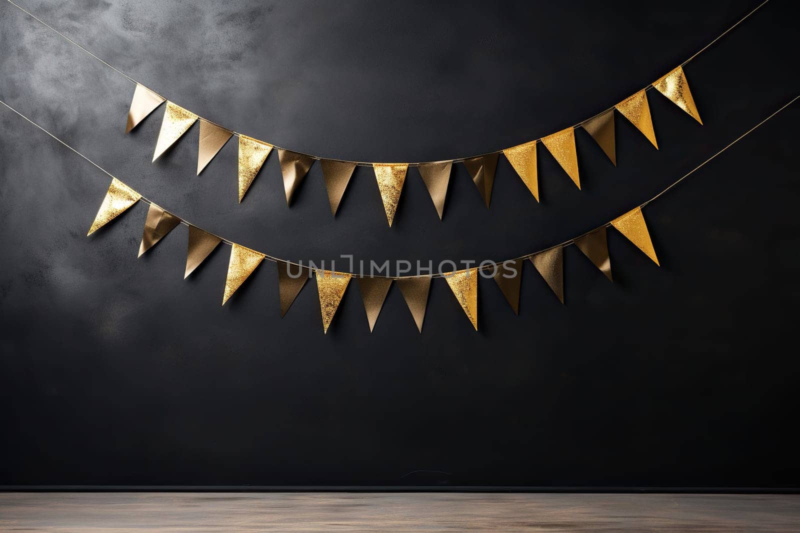 Golden garland on a black wall. Festive decoration.