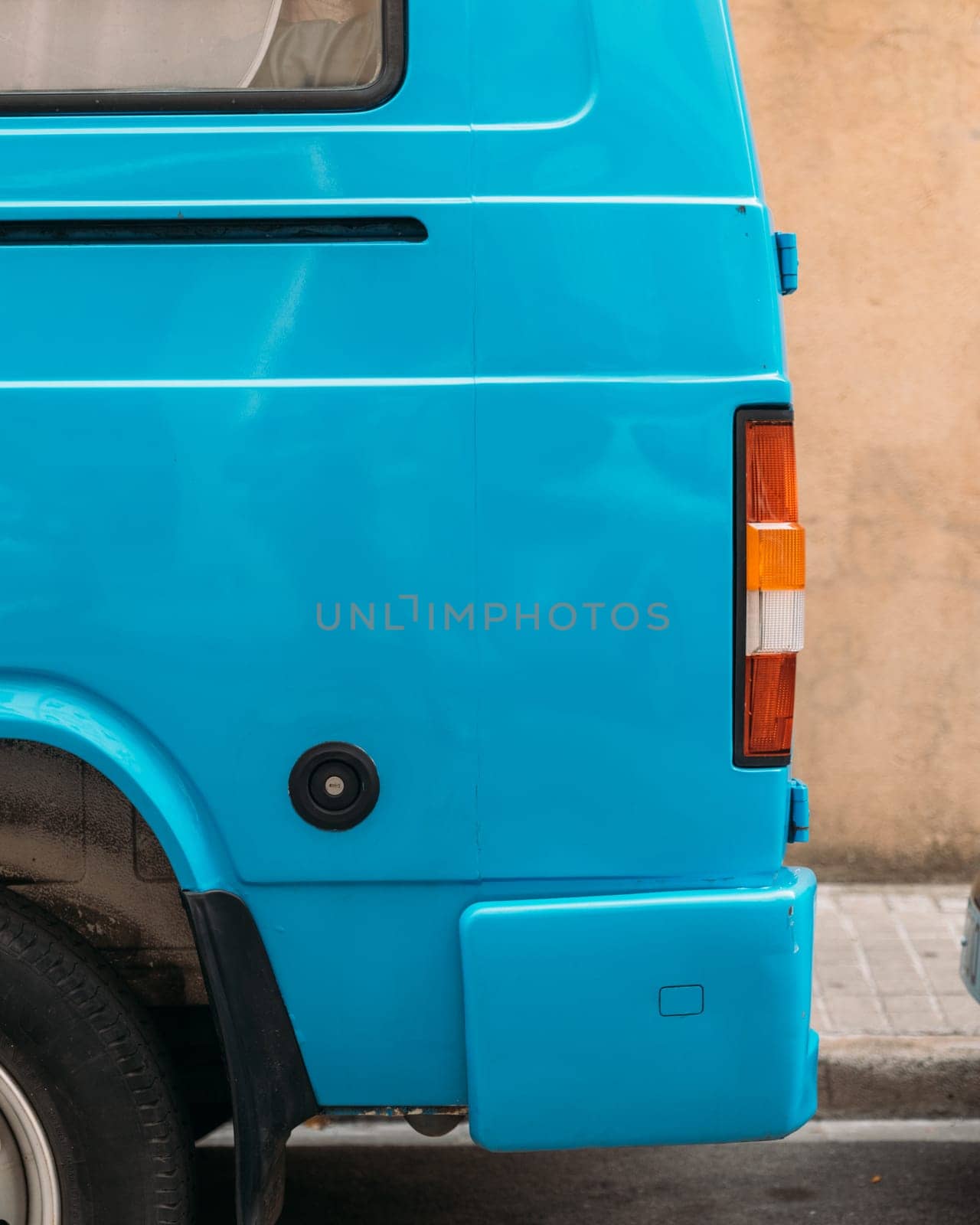 Vibrant Blue Vintage Van Parked on an Urban Street by apavlin
