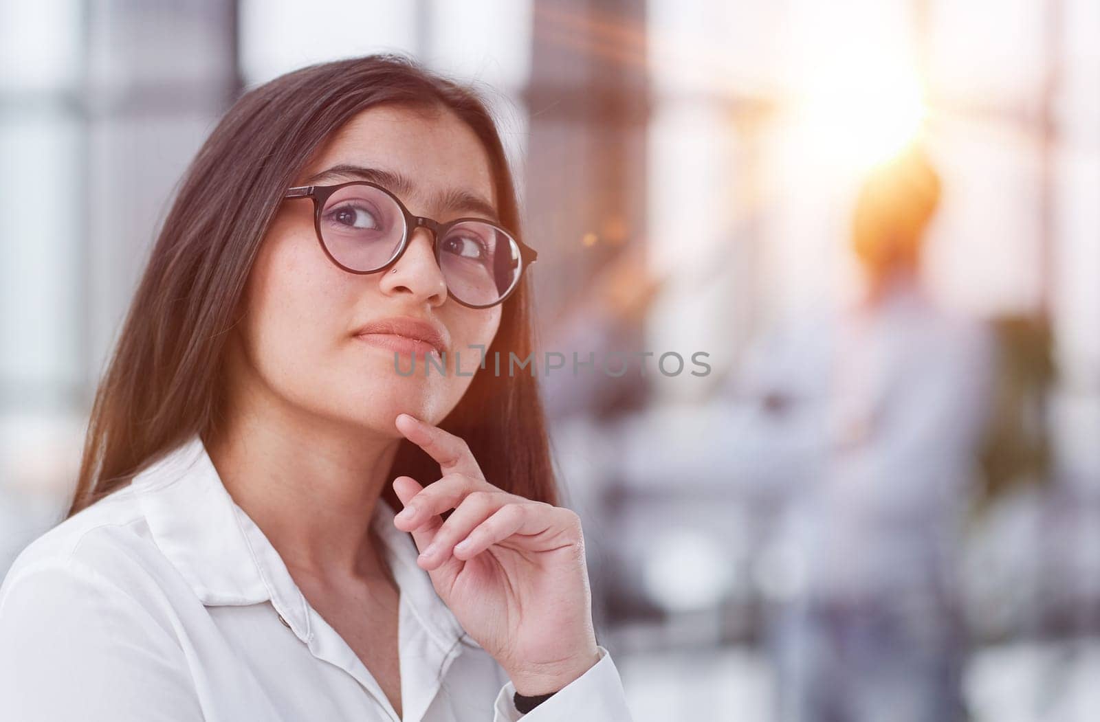 a girl stands in a modern office and looks at the camera by Prosto