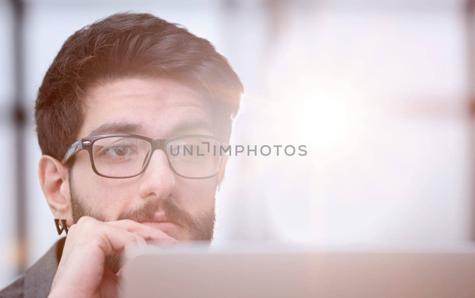 focused young businessman looking at computer monitor