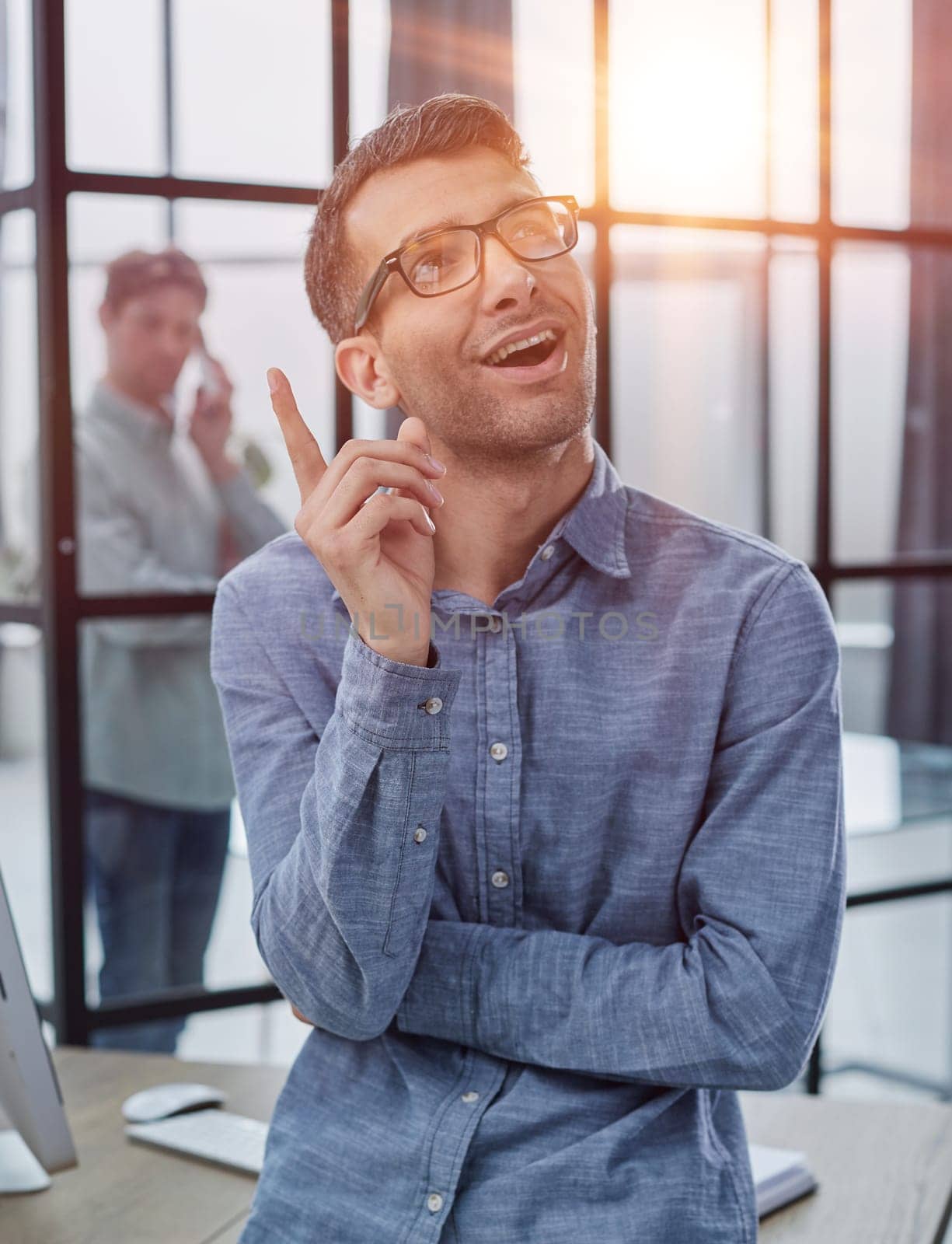 Businessman smiling outside a boardroom before meeting with colleagues