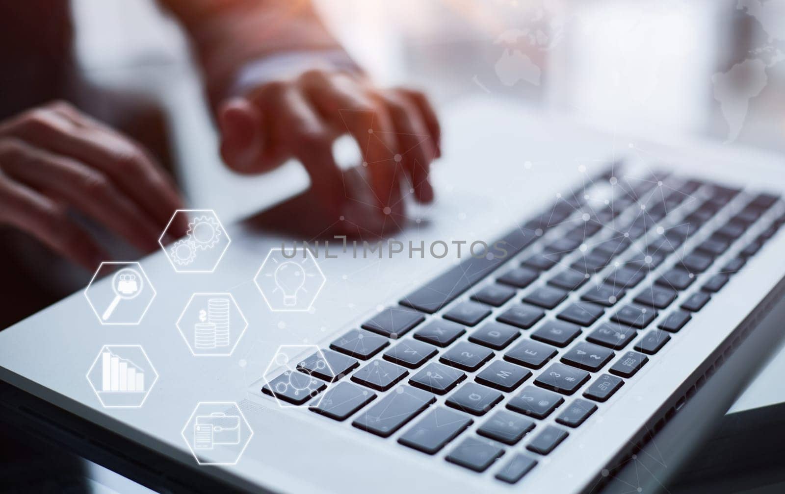 man's hands typing on laptop keyboard in interior