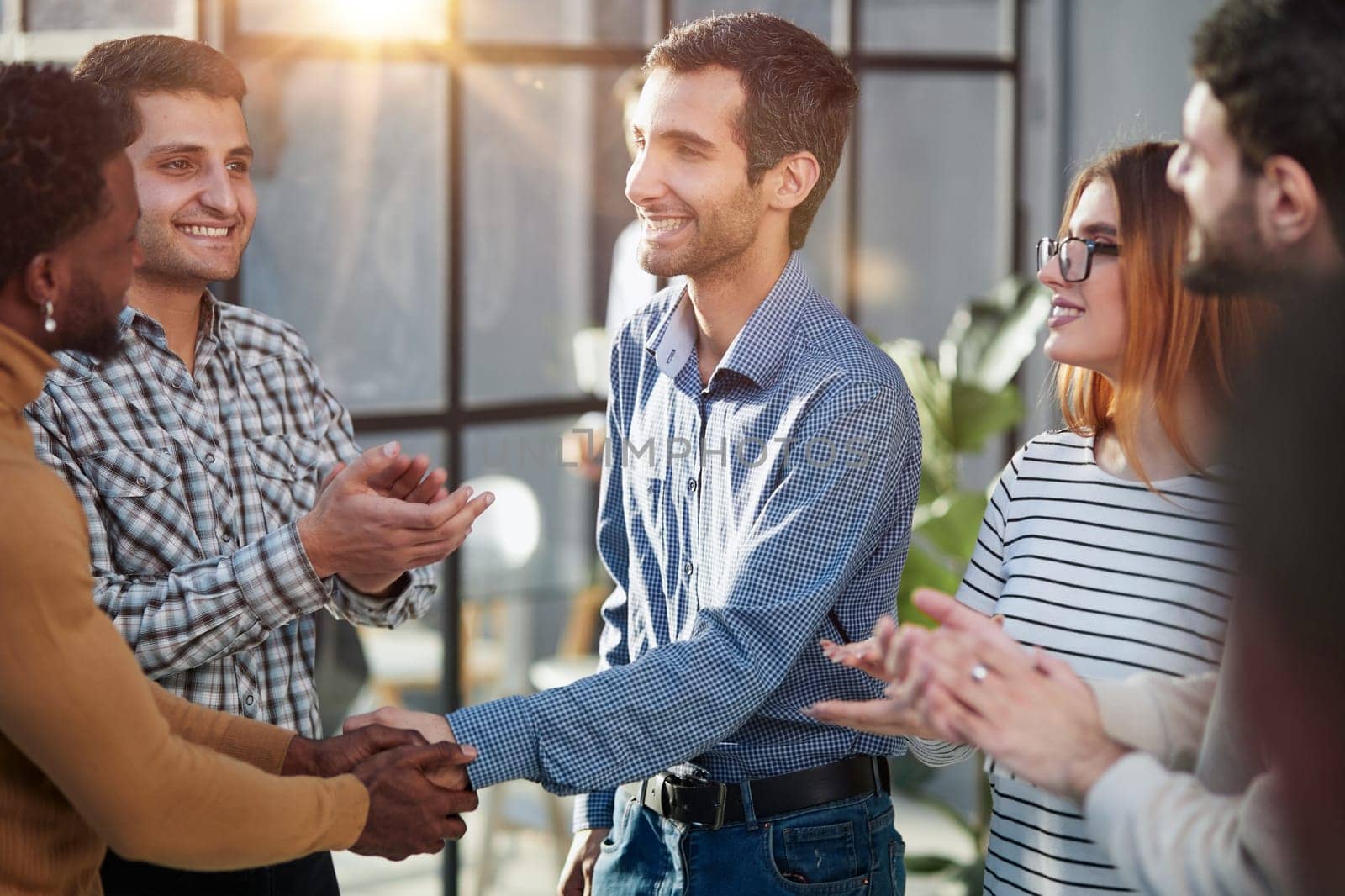 Two happy diverse professional business men executive leaders shaking hands at office meeting.