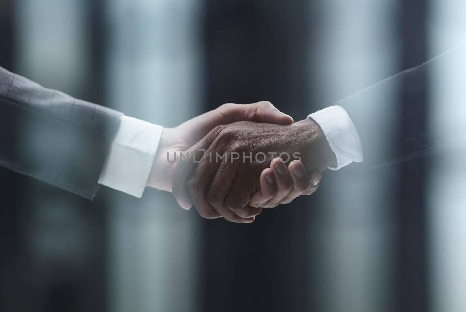 African man's hand shaking white man's hand on black background by Prosto