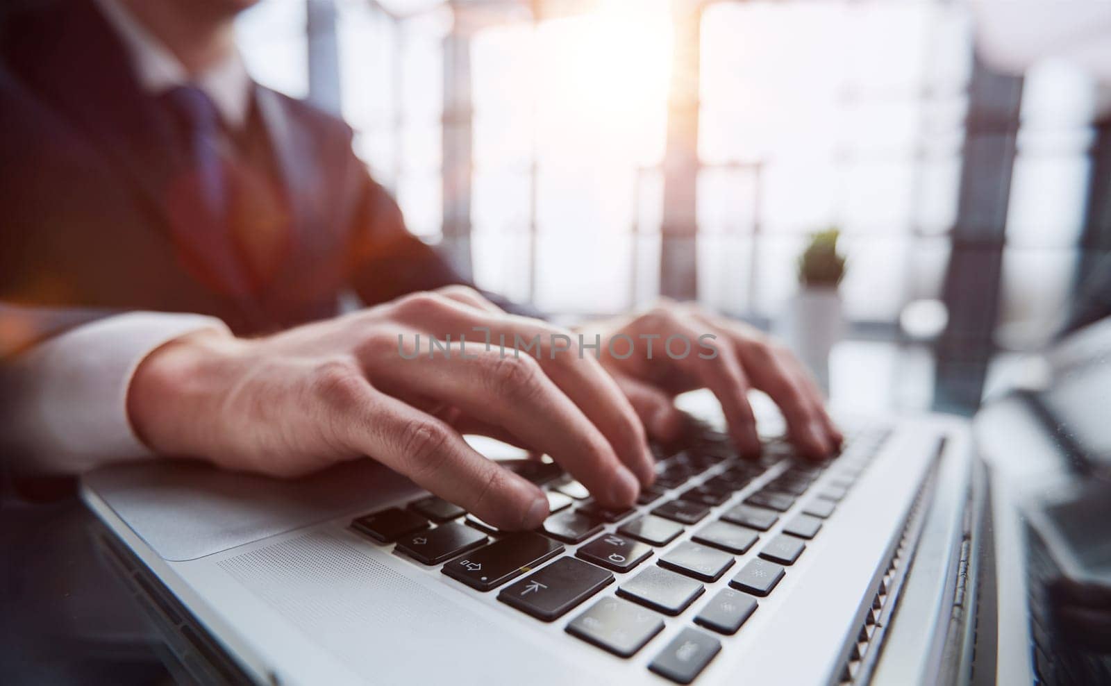 Closeup image of a man working and typing on laptop computer keyboard by Prosto