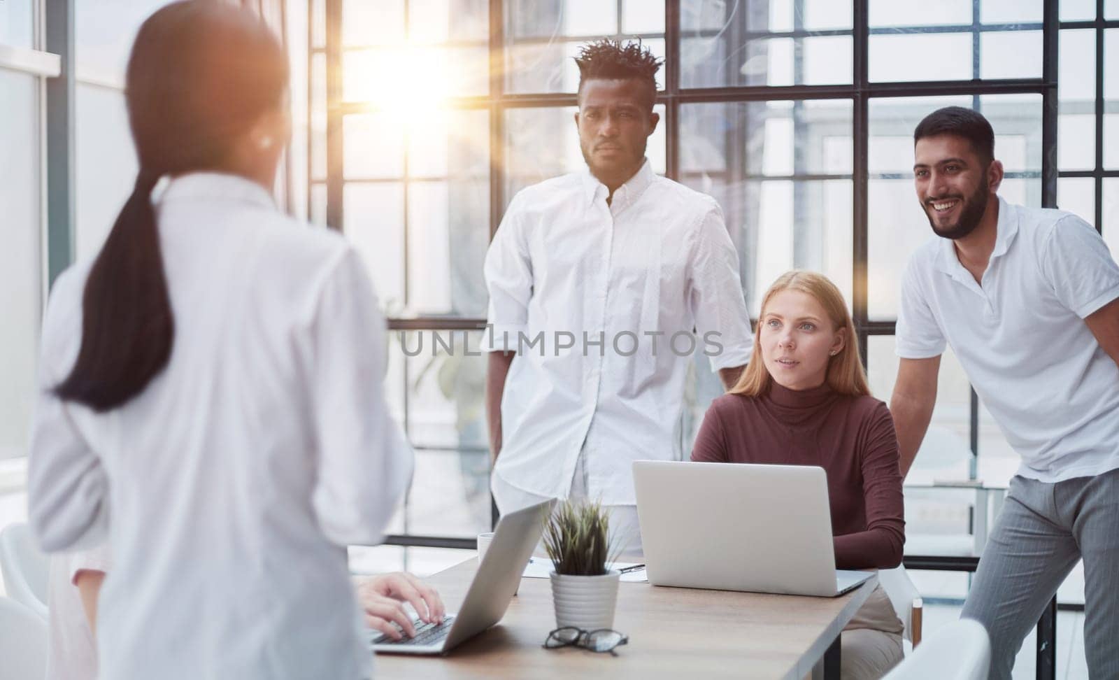 Businessmen and businesswomen talking during a meeting by Prosto