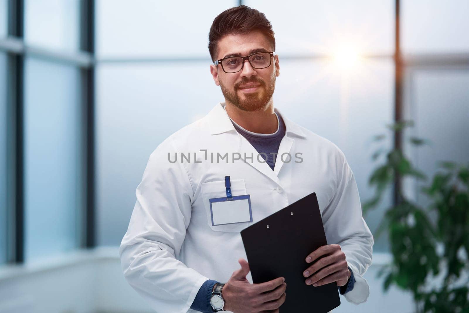 experienced doctor with a folder in his hands in the hospital