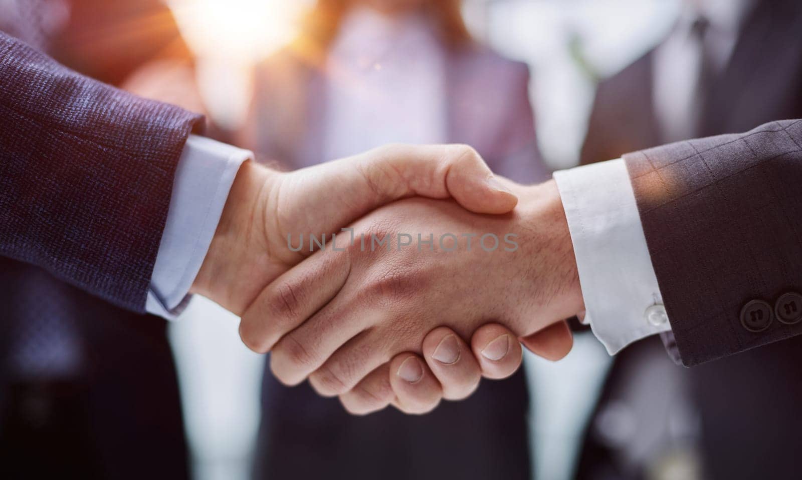 businessmen shaking hands starting teamwork partnership standing in corporate work space hallway