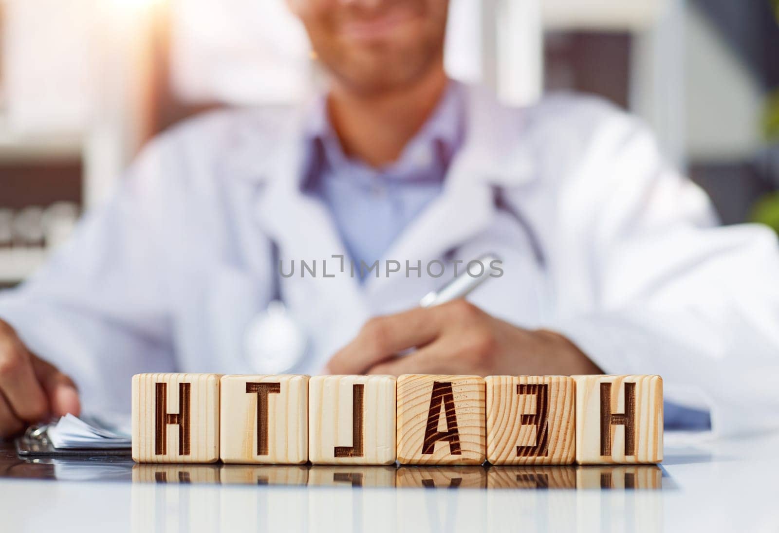 the doctor folded the word healthy from wooden cubes on the table
