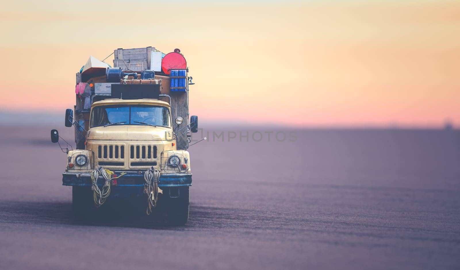 Vintage Expedition Truck In The African Desert At Sunset With Copy Space