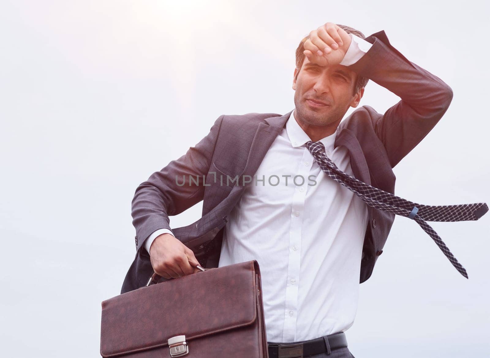 Studio shot of a mature businessman running with a briefcase.