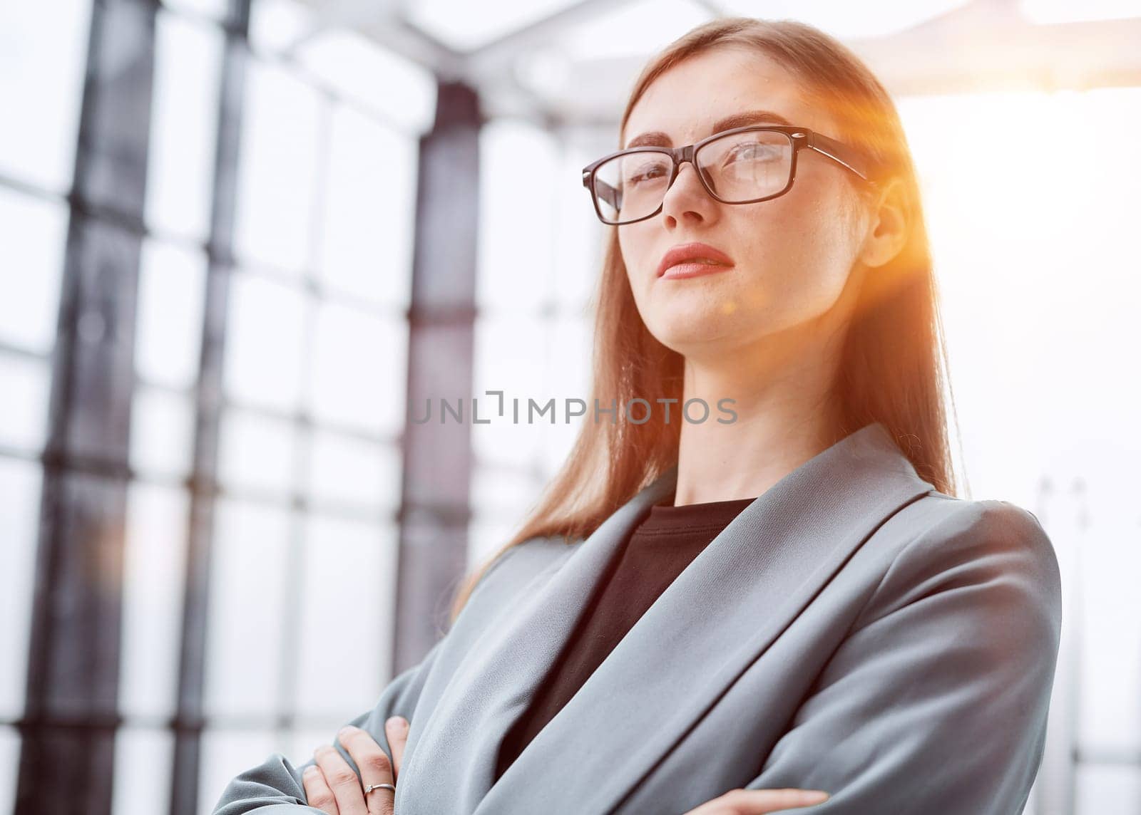 Portrait of a confident young businesswoman standing with her arms crossed in an office.