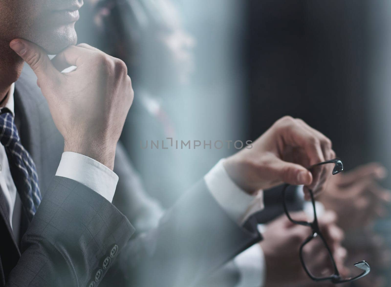 Close up of male hands holding a pair of glasses by Prosto