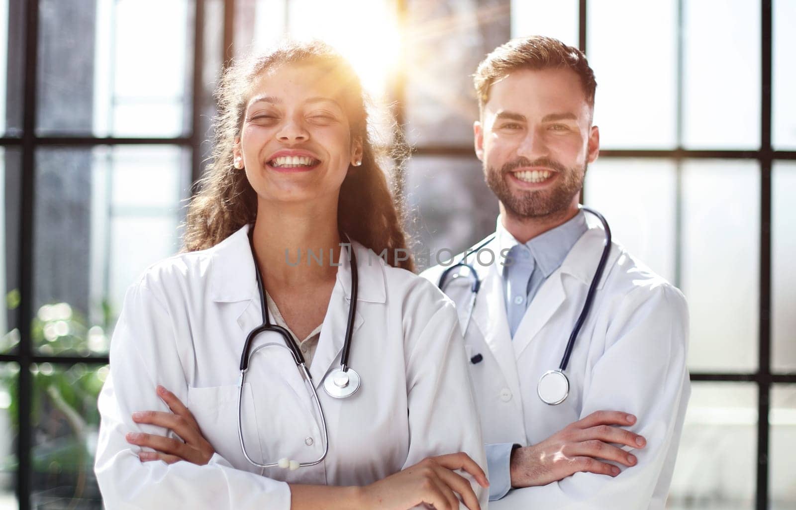 female doctor and male doctor stand in the lobby of the hospital